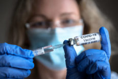 Covid-19,Vaccine,In,Researcher,Hands,,Female,Doctor,Holds,Syringe,And COVID-19 vaccine in researcher hands, female doctor holds syringe and bottle with vaccine for coronavirus cure. Concept of corona virus treatment, injection, shot and clinical trial during pandemic.