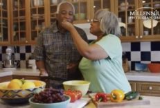 Black husband and wife eating healthy food in the kitchen