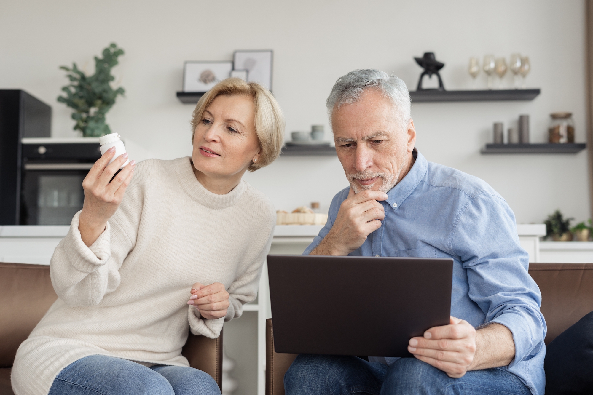 older aged couple going through their medications at home